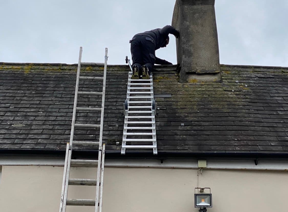 Roofer carrying out chimney repair work